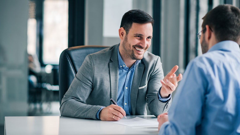 Conseillère emploi intérim expliquant offres sur écran à candidat Pamiers
